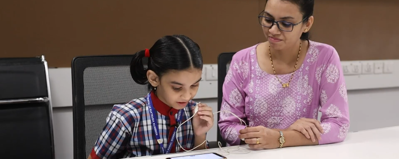 Teacher Facilitating the test of a student (Credits: Researchers)